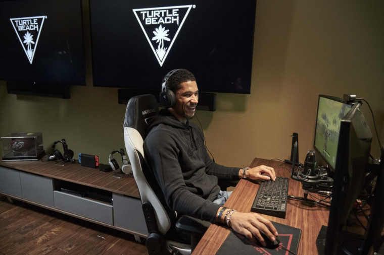 Josh Hart playing from his room with Turtle Beach gear.