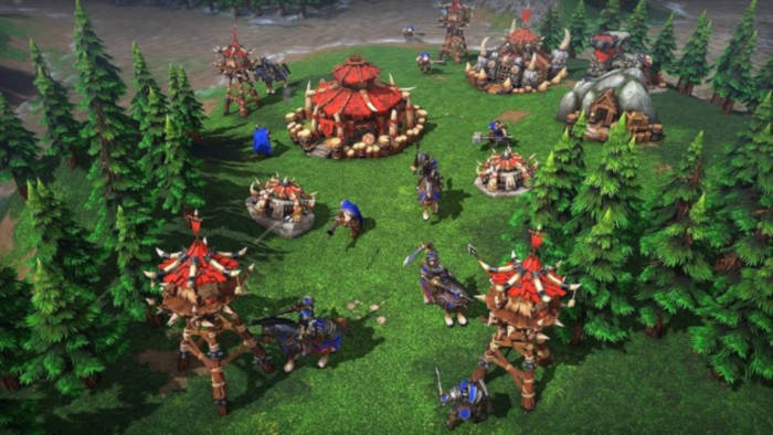 Orc settlement attacked by Human in Warcraft III reforged.